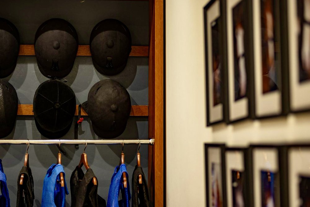 Helmets and body protectors ready for riders at Al Wadi Equestrian Center
