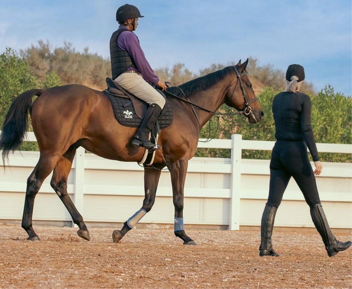 Instructor and rider during a lesson at Al Wadi Equestrian Center